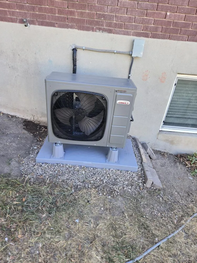 Sunny Home Services technicians installing a new air conditioner